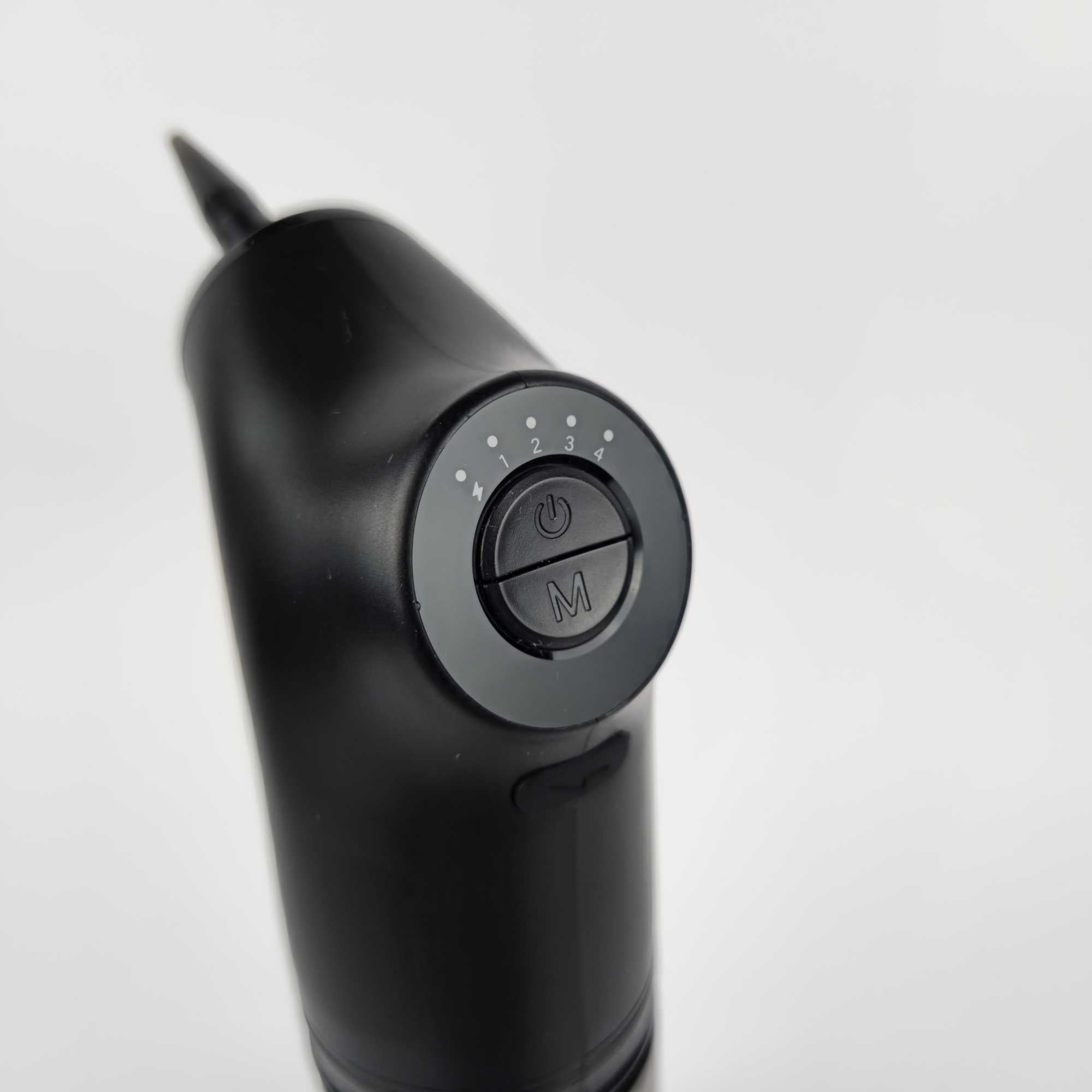 Close-up of electric ear wax removal kit control panel with buttons and settings.jpg