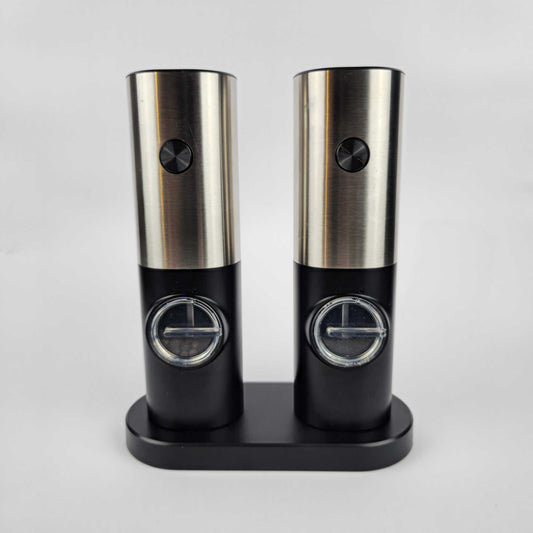 Two stainless steel and black electric spice grinders with LED lights, shown side by side on charging stand.jpg