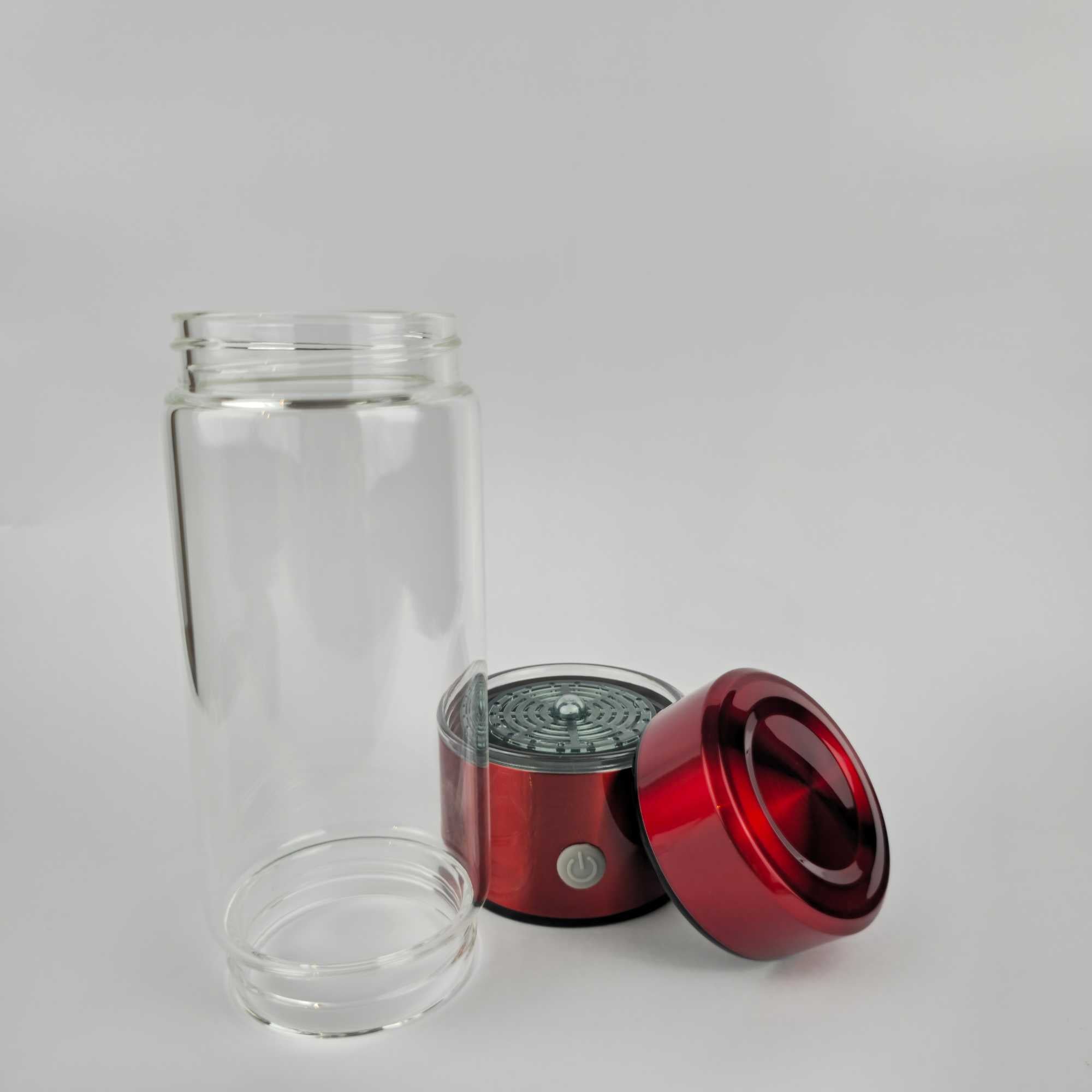 Hydrogen water bottle taken apart to show the glass body, base unit with power button, and lid.jpg