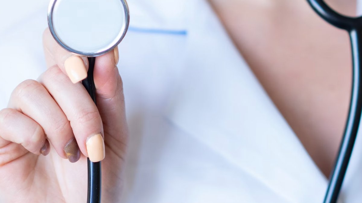 Doctor holding a stethoscope, representing when to consult a professional before using a topical cream